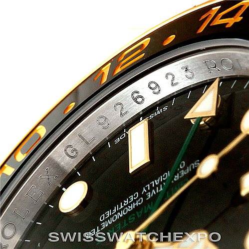 This close-up angle of the Rolex GMT-Master 116713 Men's Stainless Steel Black Dial 116713 Men's Stainless Steel Black Dial watch shows part of the dial, chapter ring, and the numbered bezel marked with "12" and "14".