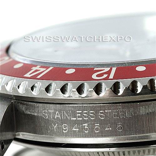 Close-up side view of a Rolex GMT-Master 16710 Men's Stainless Steel Black Dial 16710 Men's Stainless Steel Black Dial watch showing the bezel, crystal, and engraved serial number on the case.