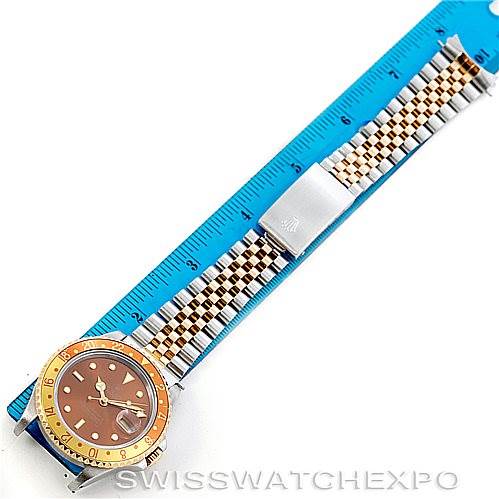 The image shows a full frontal view of a Rolex GMT-Master 16713 Men's Stainless Steel Brown Dial 16713 Men's Stainless Steel Brown Dial watch with a ruler next to it for scale.