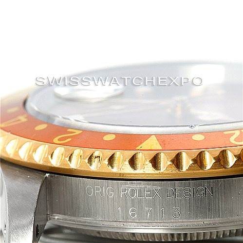 The image shows a close-up angle of the Rolex GMT-Master 16713 Men's Stainless Steel Brown Dial 16713 Men's Stainless Steel Brown Dial's bezel, crystal, and part of the case with the model number engraved.
