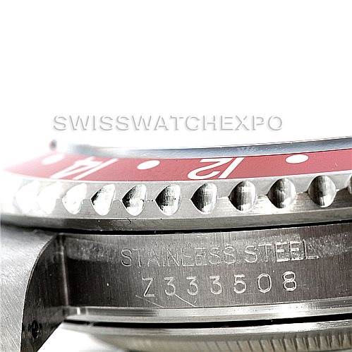 This image shows a close-up side view of a Rolex GMT-Master 16710 Men's Stainless Steel Black Dial 16710 Men's Stainless Steel Black Dial watch, highlighting part of the bezel, the engraved serial number, and the "Stainless Steel" inscription.