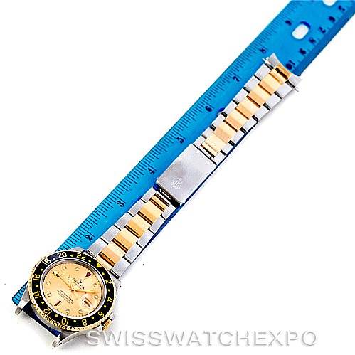 The image shows a Rolex GMT-Master 16713 Men's Stainless Steel Champagne Dial 16713 Men's Stainless Steel Champagne Dial watch laid flat with a two-tone bracelet, next to a blue ruler for size reference.