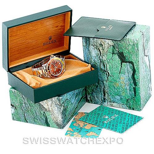 The image shows a Rolex GMT-Master 16713 Men
s Stainless Steel Brown Dial 16713 Men
s Stainless Steel Brown Dial watch in an open display box, along with its outer box and accompanying documents.
