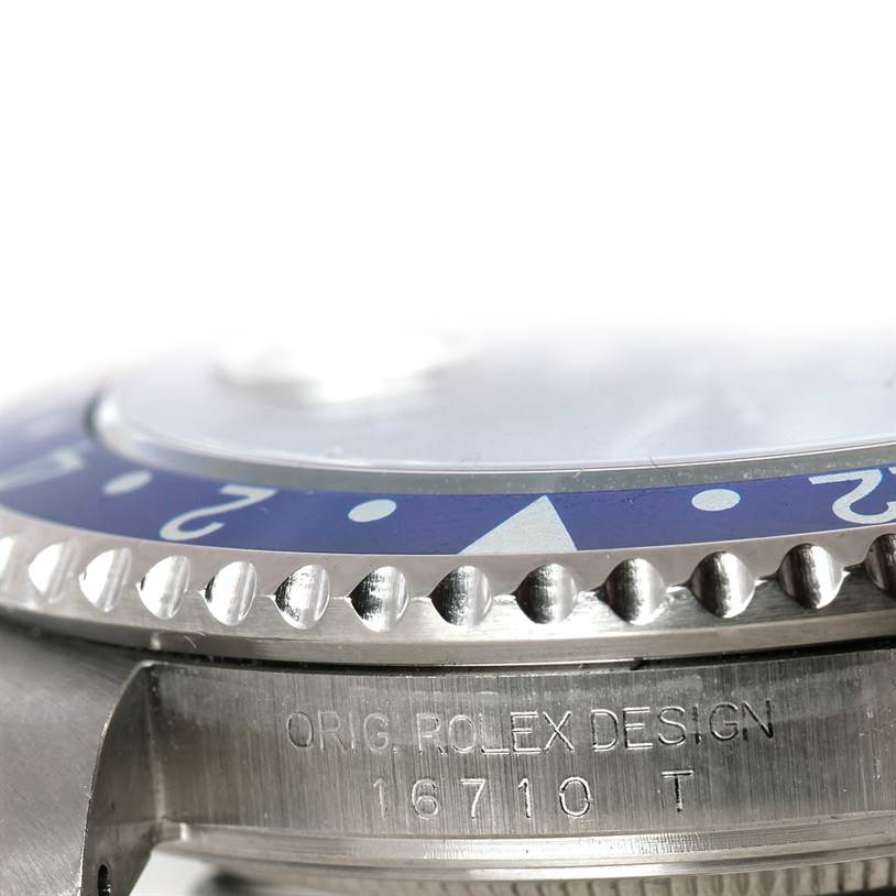 The image shows a close-up of the case and bezel of a Rolex GMT-Master 16710 Men's Stainless Steel Black Dial 16710 Men's Stainless Steel Black Dial watch, highlighting the engraved model number "16710."