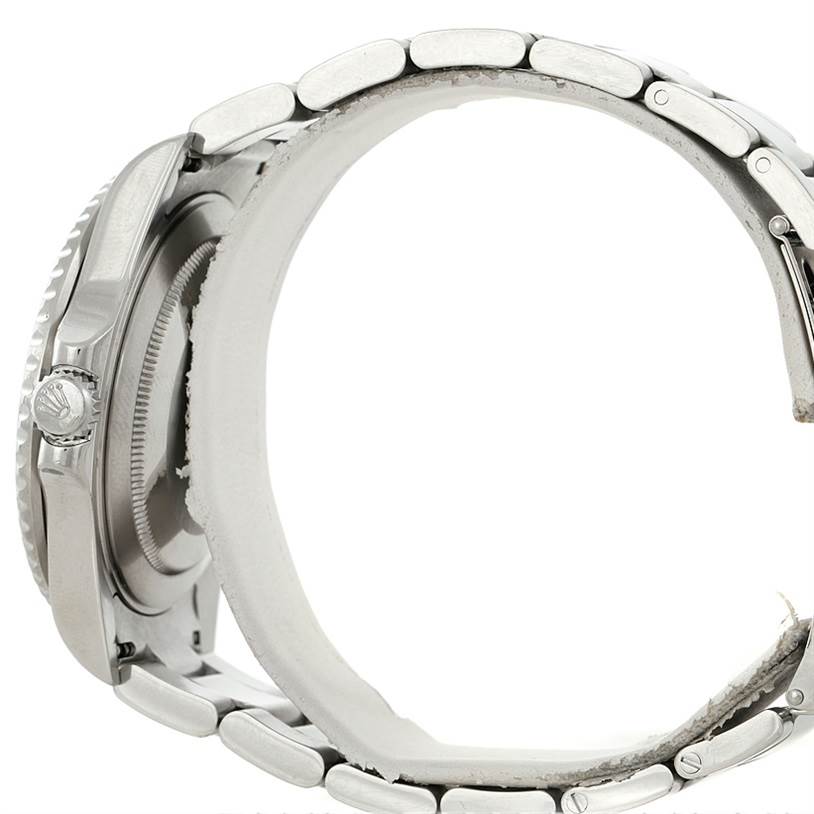 This side view of the Rolex GMT-Master 16710 Men's Stainless Steel Black Dial 16710 Men's Stainless Steel Black Dial watch shows its crown and stainless steel bracelet.