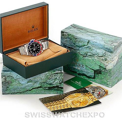 The image shows a Rolex GMT-Master 16710 Men's Stainless Steel Black Dial 16710 Men's Stainless Steel Black Dial watch at a 3/4 angle inside an open box, alongside its outer packaging and manuals.