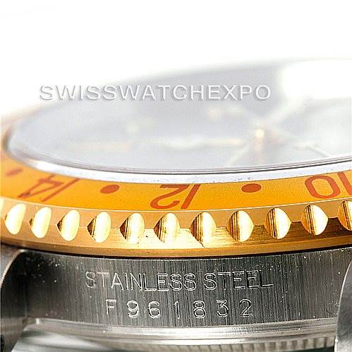 The image shows a close-up of a Rolex GMT-Master 16713 Men's Stainless Steel Grey Dial 16713 Men's Stainless Steel Grey Dial watch, highlighting part of the bezel, case, and serial number engraved on the stainless steel.