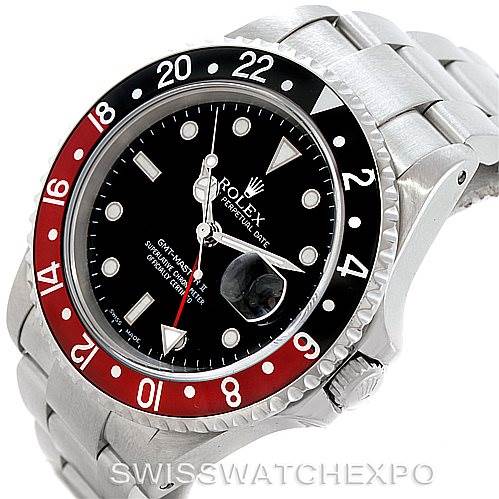 This image shows a top-side angle of a Rolex GMT-Master 16710 Men
s Stainless Steel Black Dial 16710 Men
s Stainless Steel Black Dial watch, highlighting its black and red bezel, dial, and stainless steel bracelet.