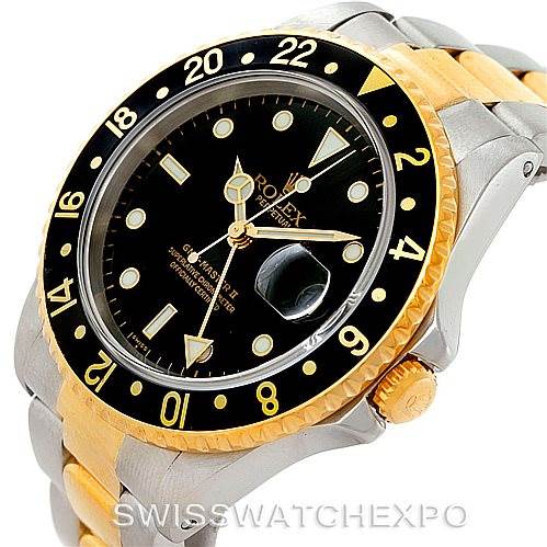 The image shows a Rolex GMT-Master 16713 Men
s Stainless Steel Black Dial 16713 Men
s Stainless Steel Black Dial watch at an angled view, featuring its bezel, crown, and part of the bracelet.