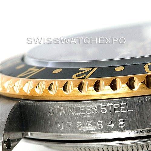 This image shows a side angle of the Rolex GMT-Master 16713 Men
s Stainless Steel Black Dial 16713 Men
s Stainless Steel Black Dial watch focusing on the bezel, part of the crystal, and the serial number on the stainless steel case.