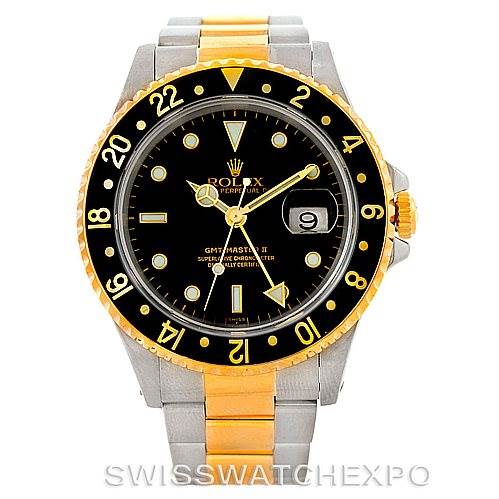 A front view of the Rolex GMT-Master 16713 Men
s Stainless Steel Black Dial 16713 Men
s Stainless Steel Black Dial watch is shown, featuring its black bezel, black dial, and two-tone stainless steel and gold bracelet.