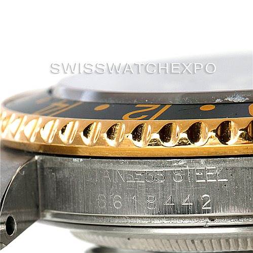 This side-angle view of the Rolex GMT-Master 16713 Men's Stainless Steel Black Dial 16713 Men's Stainless Steel Black Dial watch shows the bezel, parts of the case, and serial number etched on the stainless steel.