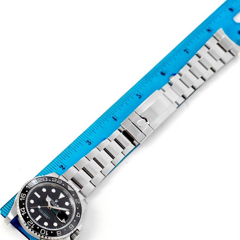 The image shows the face and band of a Rolex GMT-Master 116710 Men's Stainless Steel Black Dial 116710 Men's Stainless Steel Black Dial watch, displayed next to a ruler for scale.