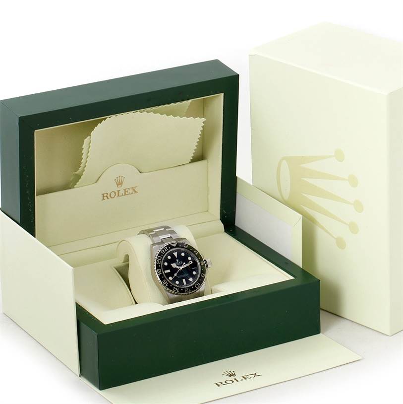 The Rolex GMT-Master 116710 Men's Stainless Steel Black Dial 116710 Men's Stainless Steel Black Dial watch is shown in its box, accompanied by the outer box and cleaning cloth.