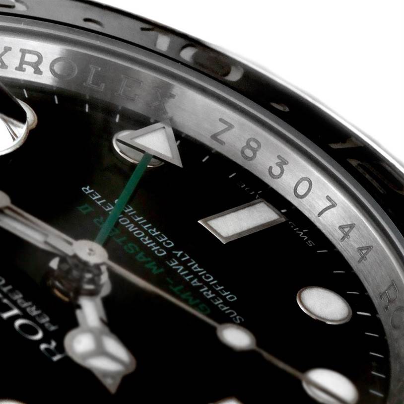 The image shows a close-up view of the dial and bezel with the serial number of a Rolex GMT-Master 116710 Men's Stainless Steel Black Dial 116710 Men's Stainless Steel Black Dial watch.