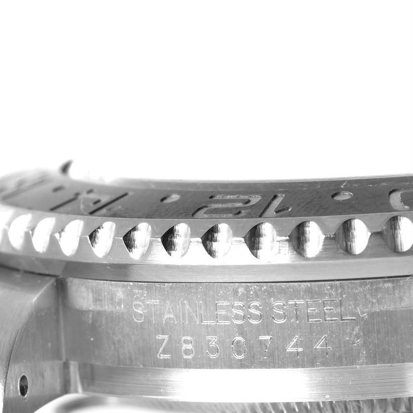 This close-up image shows the side view of the bezel and part of the case with the serial number of the Rolex GMT-Master 116710 Men's Stainless Steel Black Dial 116710 Men's Stainless Steel Black Dial watch.