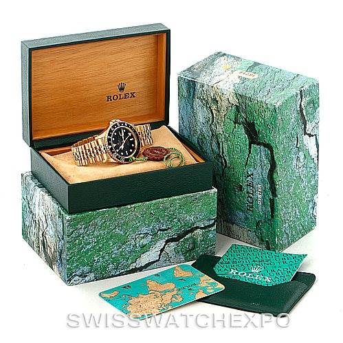The image shows a Rolex GMT-Master 16718 Men's Yellow Gold Black Dial 16718 Men's Yellow Gold Black Dial watch in its open box, with outer packaging and accompanying cards displayed around it.