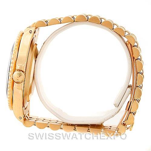 The image shows a side view of the Rolex GMT-Master 16718 Men's Yellow Gold Black Dial 16718 Men's Yellow Gold Black Dial, highlighting its crown, case, and bracelet in gold.