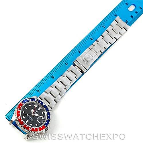 This image shows the Rolex GMT-Master 16710 Men's Stainless Steel Black Dial 16710 Men's Stainless Steel Black Dial watch laid flat against a blue ruler, displaying the watch face, bezel, and metal bracelet.