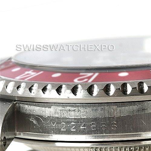 The image shows a side view of a Rolex GMT-Master 16710 Men's Stainless Steel Black Dial 16710 Men's Stainless Steel Black Dial, featuring the bezel and part of the case with engraved serial numbers.