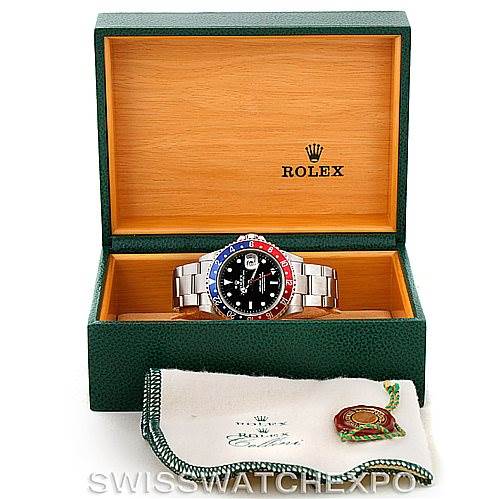 The Rolex GMT-Master 16710 Men's Stainless Steel Black Dial 16710 Men's Stainless Steel Black Dial watch is shown from the front, placed inside an open green box with a cloth accessory in front.