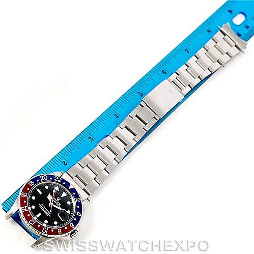The image shows a Rolex GMT-Master 16750 Men's Stainless Steel Black Dial 16750 Men's Stainless Steel Black Dial watch laid flat next to a blue ruler, emphasizing its bracelet and bezel.