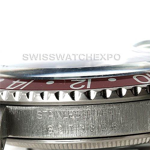 This image shows a close-up side view of the GMT-Master Rolex watch, highlighting the bezel, part of the dial, and the serial number.