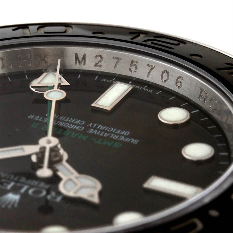This close-up shows the dial, hands, and case with engraved serial number of the Rolex GMT-Master 116710 Men
s Stainless Steel Black Dial 116710 Men
s Stainless Steel Black Dial watch.