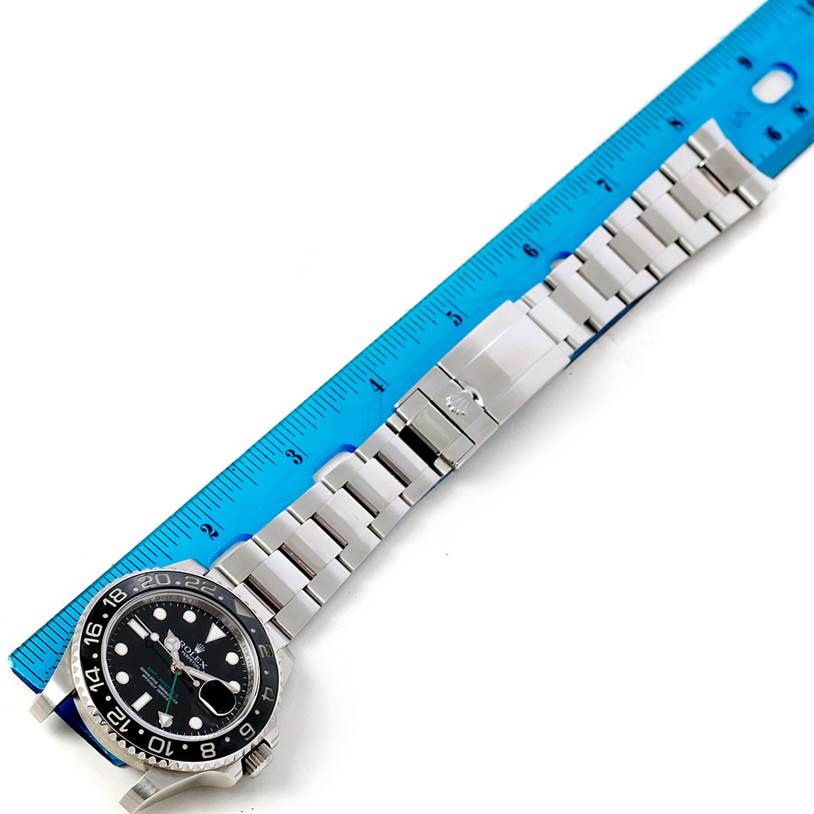The image shows the front view of a Rolex GMT-Master 116710 Men
s Stainless Steel Black Dial 116710 Men
s Stainless Steel Black Dial watch with a ruler measuring its band length.