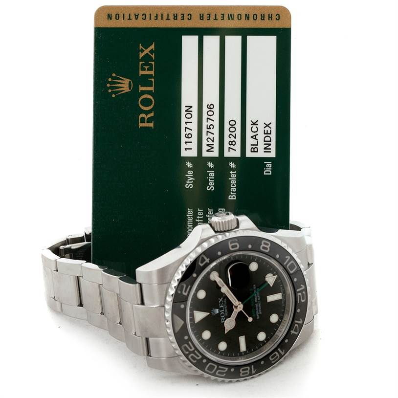 The photo shows a side view of a Rolex GMT-Master 116710 Men
s Stainless Steel Black Dial 116710 Men
s Stainless Steel Black Dial watch with the certificate card visible in the background.