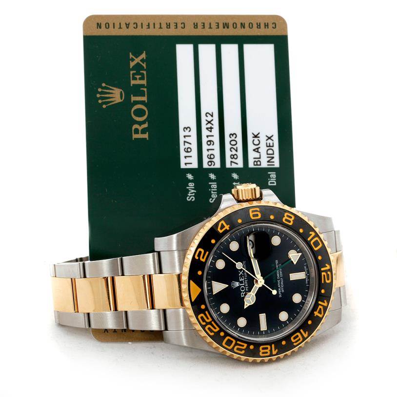 The image shows a Rolex GMT-Master 116713 Men's Stainless Steel Black Dial 116713 Men's Stainless Steel Black Dial watch with a two-tone bracelet, black dial, and a certification card placed behind it.