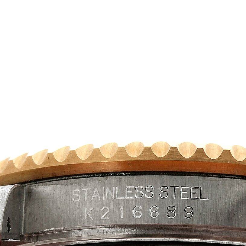 This close-up view shows the engraved serial number and part of the bezel on a Rolex GMT-Master 16713 Men's Stainless Steel Black Dial 16713 Men's Stainless Steel Black Dial watch.