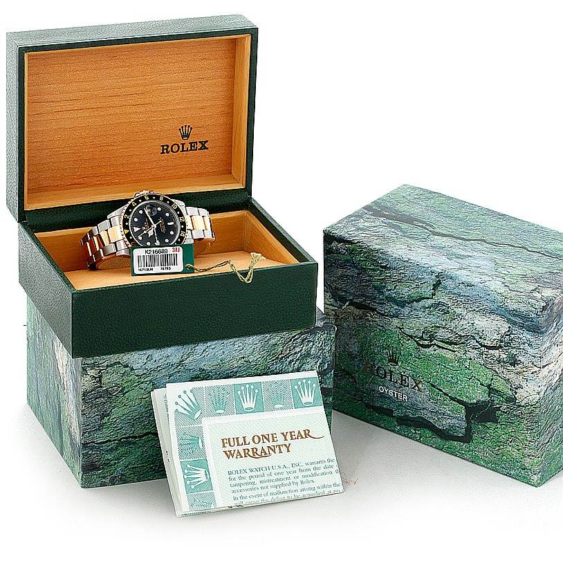 The image shows a Rolex GMT-Master 16713 Men's Stainless Steel Black Dial 16713 Men's Stainless Steel Black Dial watch in its open box, alongside another closed box and warranty booklet.