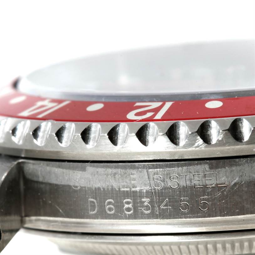 The image shows a detailed close-up of the bezel and case side of a Rolex GMT-Master 16710 Men's Stainless Steel Black Dial 16710 Men's Stainless Steel Black Dial watch, highlighting the serial number.