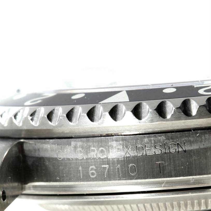 The image shows a close-up, side view of the bezel and case of a Rolex GMT-Master 16710 Men's Stainless Steel Black Dial 16710 Men's Stainless Steel Black Dial model with the design number 16710.