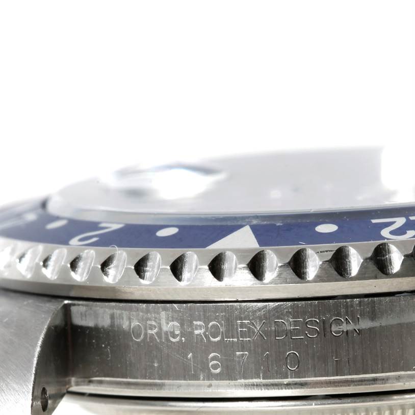 This close-up image of a Rolex GMT-Master 16710 Men's Stainless Steel Black Dial 16710 Men's Stainless Steel Black Dial watch shows the edge of the bezel and part of the case with the engraved model number "16710".