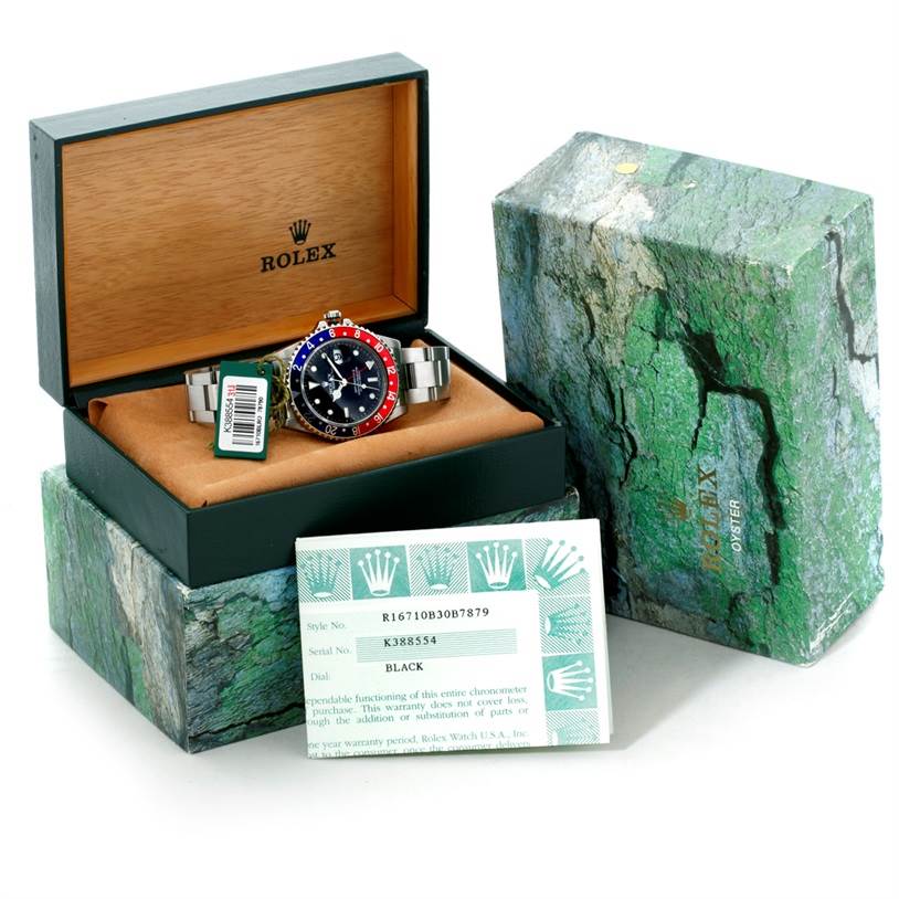 The Rolex GMT-Master 16710 Men's Stainless Steel Black Dial 16710 Men's Stainless Steel Black Dial watch is shown in its box from a front angle, with packaging and warranty card.