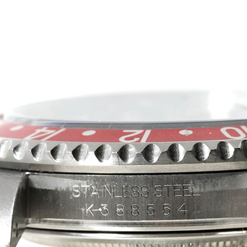 This image shows a side view of a Rolex GMT-Master 16710 Men's Stainless Steel Black Dial 16710 Men's Stainless Steel Black Dial's bezel and case, highlighting the stainless steel engraving and partial bezel.