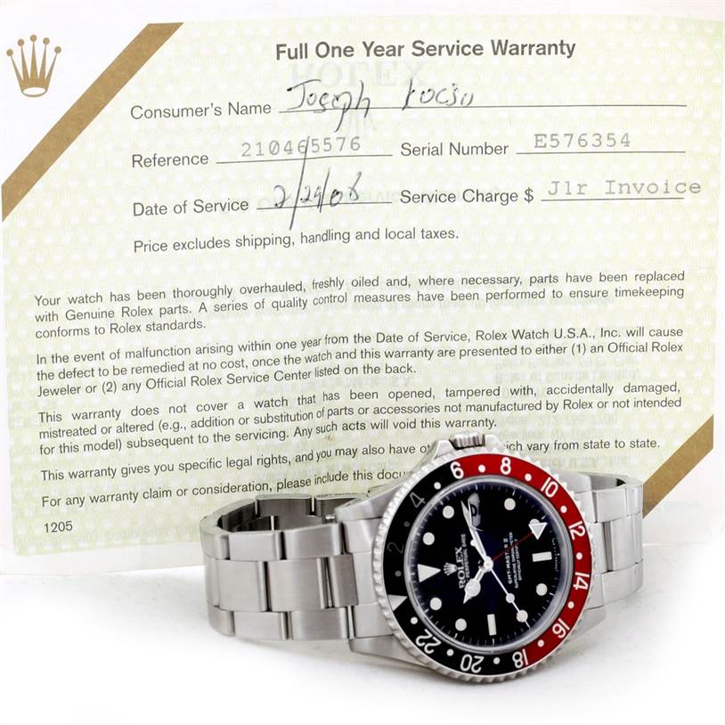 The image shows a Rolex GMT-Master 16710 Men's Stainless Steel Black Dial 16710 Men's Stainless Steel Black Dial watch in a near-horizontal angle, partially resting on its warranty document.