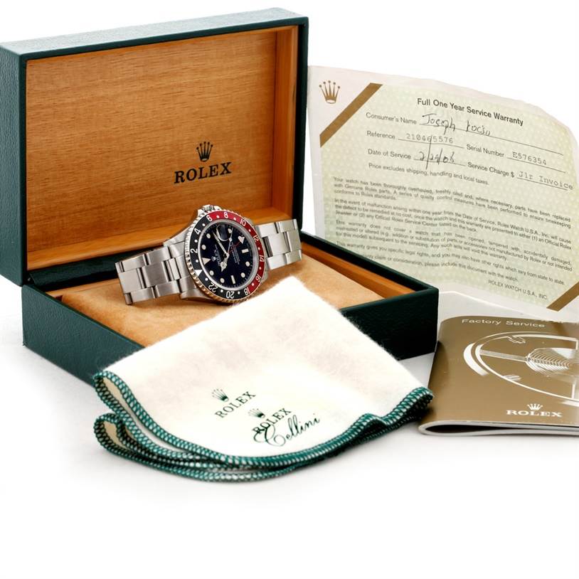 This image shows a Rolex GMT-Master 16710 Men's Stainless Steel Black Dial 16710 Men's Stainless Steel Black Dial watch in its box, along with a warranty card, cleaning cloth, and booklet.