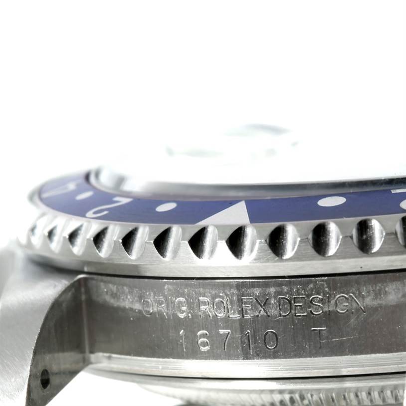 This close-up image of the Rolex GMT-Master 16710 Men's Stainless Steel Black Dial 16710 Men's Stainless Steel Black Dial shows the engraved side of the case and the bezel with its markings.
