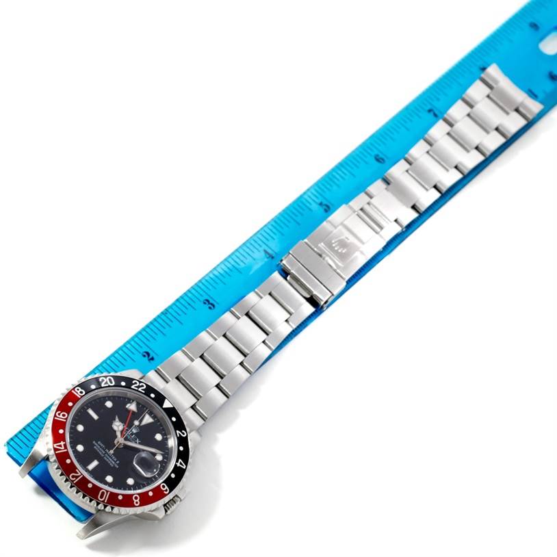 The Rolex GMT-Master 16710 Men's Stainless Steel Black Dial 16710 Men's Stainless Steel Black Dial watch is shown from above in full length with the dial, bezel, and bracelet visible, placed alongside a ruler.