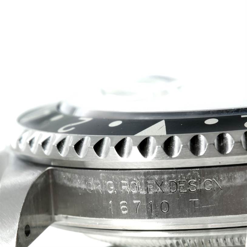 The image shows a close-up of the case side and the numbered bezel of a Rolex GMT-Master 16710 Men's Stainless Steel Black Dial 16710 Men's Stainless Steel Black Dial model, highlighting the model number 16710T.