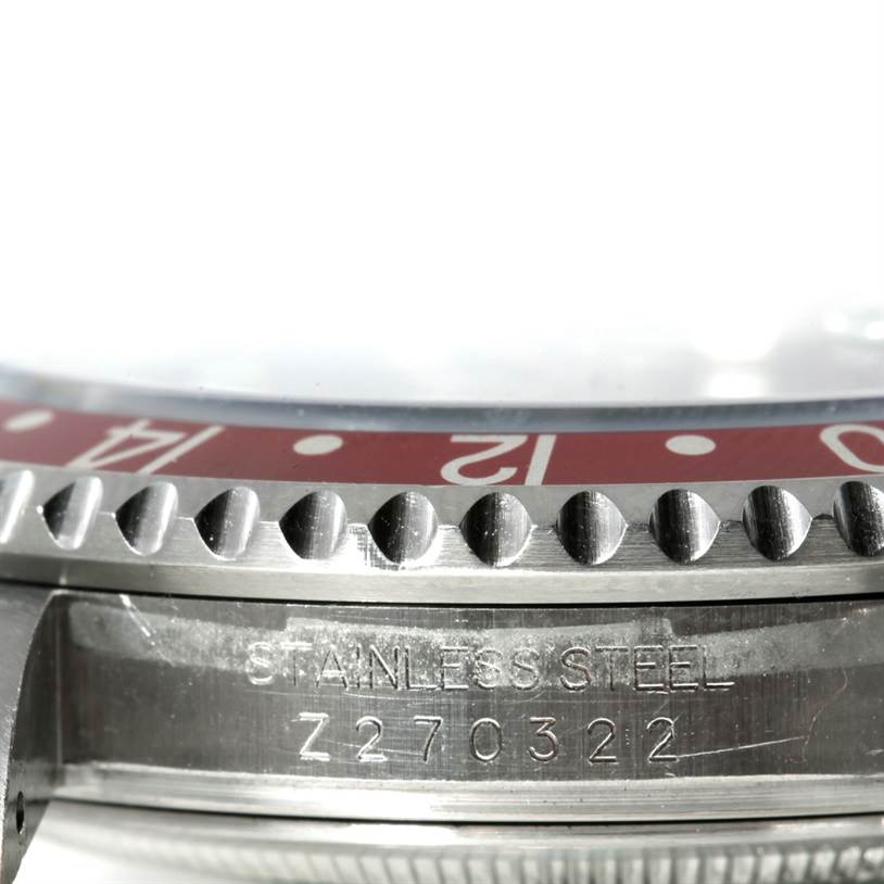 This close-up image shows the stainless steel bezel and part of the case back of the Rolex GMT-Master 16710 Men's Stainless Steel Black Dial 16710 Men's Stainless Steel Black Dial watch.