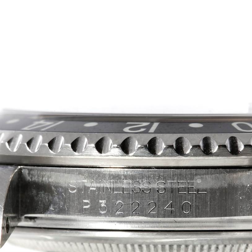 This image shows a close-up side view of the bezel, case, and serial number of a Rolex GMT-Master 16710 Men's Stainless Steel Black Dial 16710 Men's Stainless Steel Black Dial watch.