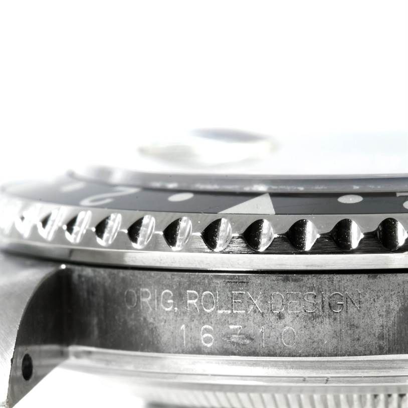 The image shows a close-up side view of the bezel, part of the dial, and the engraved case of a Rolex GMT-Master 16710 Men's Stainless Steel Black Dial 16710 Men's Stainless Steel Black Dial watch.