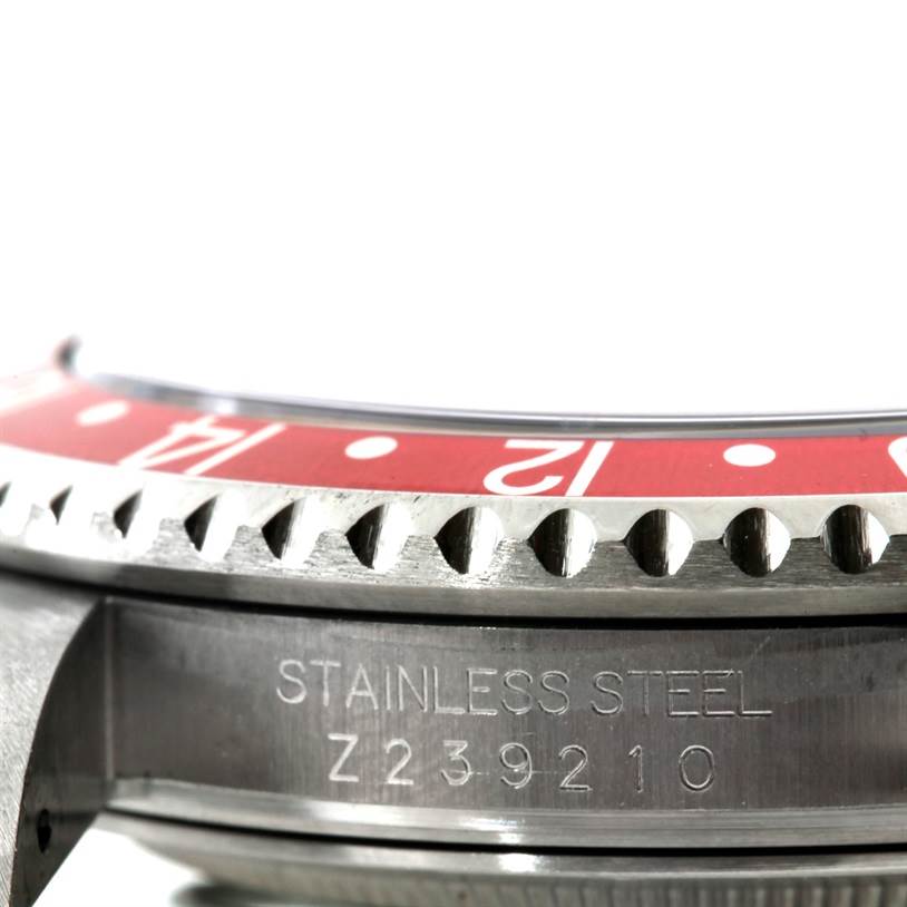 Close-up of the GMT-Master bezel and case by Rolex, showing the bezel edge and stainless steel with the serial number.