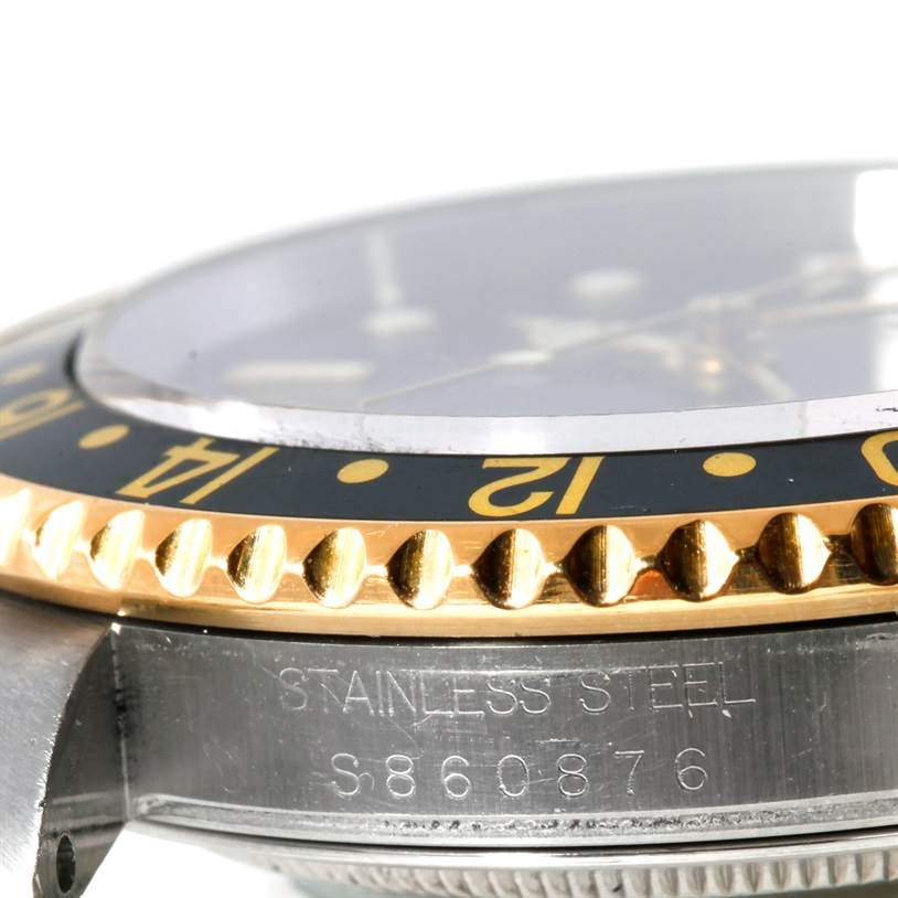 The image shows a close-up angle of the bezel, crystal, and part of the case of the Rolex GMT-Master 16713 Men's Stainless Steel Black Dial 16713 Men's Stainless Steel Black Dial watch.