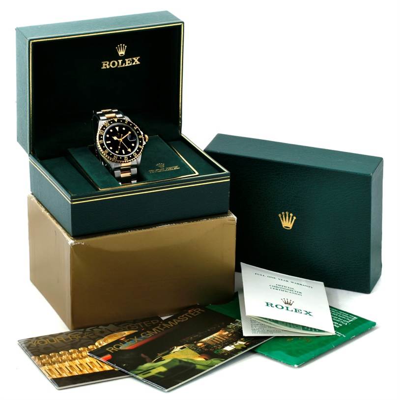 The image shows a Rolex GMT-Master 16713 Men's Stainless Steel Black Dial 16713 Men's Stainless Steel Black Dial watch from a front angle, displayed in an open box with accompanying booklets and packaging.