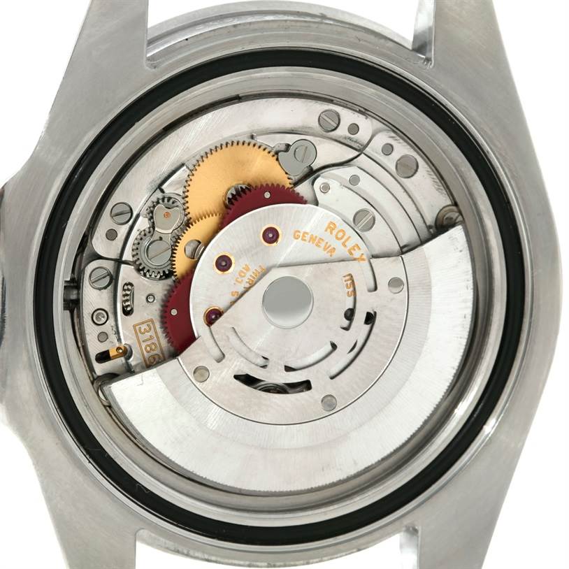 This image shows the movement and internal mechanism of a Rolex GMT-Master 116710 Men's Stainless Steel Black Dial 116710 Men's Stainless Steel Black Dial watch from the back, exposing the gears and rotor.